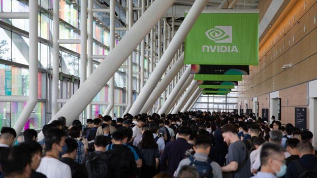 Corredor movimentado da Computex 2024 com grande público em frente ao estande da NVIDIA, destacando o interesse pelas inovações em inteligência artificial.